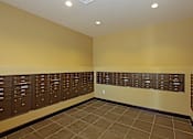 Thumbnail 21 of 50 - A hallway with brown lockers and a tiled floor.