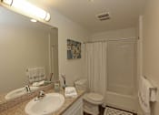 Thumbnail 50 of 50 - A bathroom with a sink, toilet, and shower.