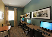 Thumbnail 18 of 50 - A room with two computers and a table.