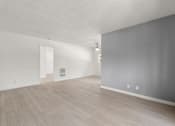 Thumbnail 16 of 35 - A room with light grey walls and a light brown floor.