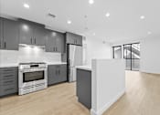 Thumbnail 107 of 119 - A modern kitchen with a white island in the middle.