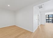 Thumbnail 36 of 119 - A room with wooden flooring and white walls.