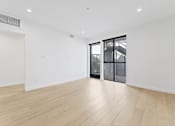 Thumbnail 111 of 119 - A room with a wooden floor and a sliding glass door.
