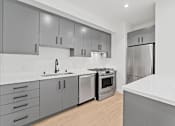 Thumbnail 59 of 119 - A modern kitchen with a stainless steel oven and refrigerator.