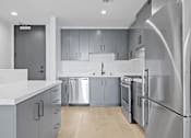 Thumbnail 106 of 119 - A modern kitchen with stainless steel appliances and wooden floors.