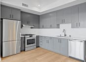 Thumbnail 30 of 119 - A modern kitchen with a stainless steel refrigerator and a dishwasher.