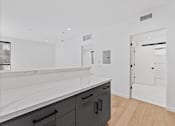 Thumbnail 66 of 119 - A kitchen with black cabinets and a white counter top.