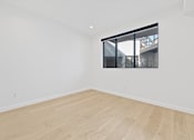 Thumbnail 114 of 119 - A room with a window and wooden flooring.