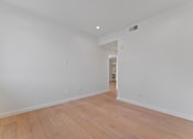 Thumbnail 96 of 119 - A room with wooden flooring and white walls.