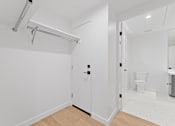 Thumbnail 68 of 119 - A white bathroom with a toilet and sink.