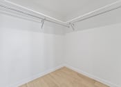 Thumbnail 118 of 119 - A white wall with a wooden floor and a white ceiling with a metal rod.