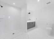 Thumbnail 108 of 119 - A white bathroom with a toilet, sink, and shower.