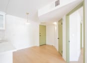 Thumbnail 5 of 28 - an empty living room with a hard wood floor and white walls