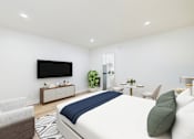 Thumbnail 22 of 79 - A modern bedroom with a large bed and a flat screen TV mounted on the wall.