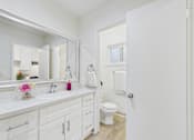 Thumbnail 15 of 79 - A white bathroom with a toilet and sink.