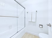 Thumbnail 48 of 49 - A white bathroom with a towel hanging on the wall.