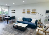 Thumbnail 23 of 29 - Living room with wood-inspired floors throughout, recessed lighting, dining area and balcony on the left.