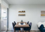 Thumbnail 27 of 29 - Dining area with wood-inspired floors, balcony on the left. Not all features are available in every apartments