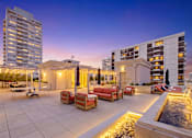 Thumbnail 51 of 56 - A rooftop patio with a fountain and seating area.