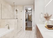 Thumbnail 9 of 53 - A bathroom with a white tub and a white sink.