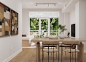 Thumbnail 4 of 53 - A dining room with a table and chairs and a painting on the wall.