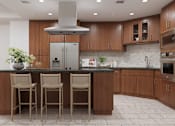 Thumbnail 2 of 53 - A kitchen with a black granite countertop and wooden cabinets.