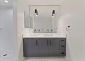 Thumbnail 99 of 119 - A bathroom with a sink, mirror, and cabinets.
