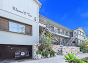 Thumbnail 15 of 16 - A car is parked in a garage under a building with the sign "Ellevue O'Two".