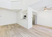 Thumbnail 18 of 115 - A room with a wooden floor and a ceiling fan.
