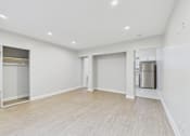 Thumbnail 43 of 49 - A spacious room with a wooden floor and white walls.