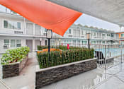 Thumbnail 41 of 49 - A building with a pool and a red tarp covering the area.