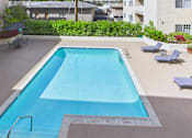 Thumbnail 12 of 17 - A rectangular pool with a metal ladder on the side.