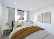 Thumbnail 4 of 32 - a white bedroom with a bed and a window