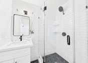 Thumbnail 22 of 32 - A white bathroom with a walk in shower.