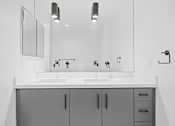 Thumbnail 115 of 119 - A bathroom with a sink and mirror.