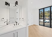 Thumbnail 33 of 119 - A bathroom with a white sink and mirror.