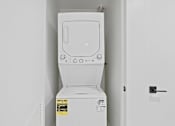Thumbnail 70 of 119 - A white toilet with a sticker on the side is in a room.