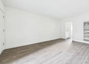Thumbnail 18 of 33 - A room with wooden flooring and white walls.