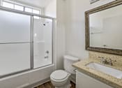 Thumbnail 19 of 35 - A bathroom with a toilet, sink, and shower.