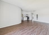 Thumbnail 26 of 75 - A room with wooden flooring and white walls.
