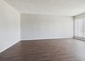 Thumbnail 31 of 75 - A room with wooden flooring and white walls.