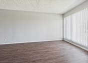 Thumbnail 32 of 75 - A room with wooden flooring and white walls.