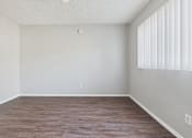 Thumbnail 35 of 75 - A room with wooden flooring and white walls.