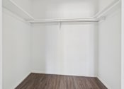 Thumbnail 40 of 75 - A room with white walls and a wooden floor.