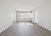 Thumbnail 49 of 75 - A room with light wood flooring and white walls.