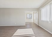 Thumbnail 51 of 75 - A room with a white mat on the floor and a window with white curtains.