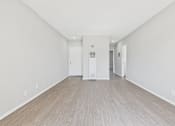 Thumbnail 57 of 75 - A room with a white door and a white cabinet.