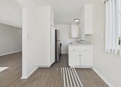 Thumbnail 45 of 75 - A kitchen with white cabinets and a black refrigerator.