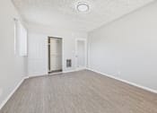 Thumbnail 54 of 75 - A room with a light brown floor and white walls.