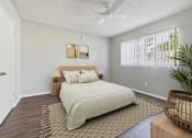 Thumbnail 14 of 91 - A bedroom with a large bed and a ceiling fan.